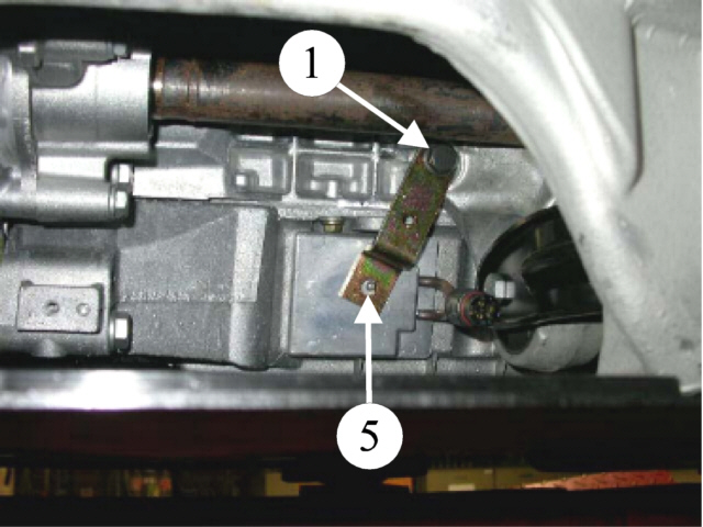 7 7/10 Varmeren monteres på bunnpannen i F. Rengjør bunnpannen godt i området der varmeren skal sitte. Demonter bolten (1) for motorfestet.