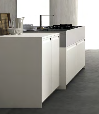/ The free-standing block with Corian worktop has storage, fridge and ovens within and is also a partition to the welcome area with the elegant table in Termocotto oak.