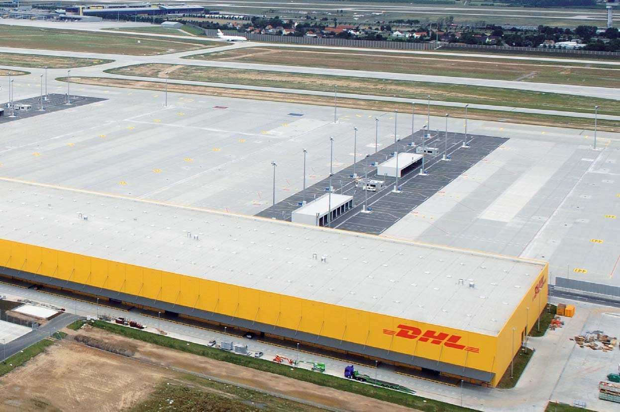 Hightech-Logistik für mehr Wachstum: Kernstücke des neuen DHL Hub Leipzig/Halle sind das Verteilzentrum im Vordergrund (auch Warehouse genannt) und der Flugzeughangar (hinten links).