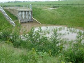 Juni 2013, gegen 19 Uhr, am umgelegten Gras ist zu erkennen, dass der Hochwasserabfluss bereits zurückgegangen ist Abb. 54a (links): teilweise eingestautes HWRB Weidigtbach, 2. Juni 2013 Abb.