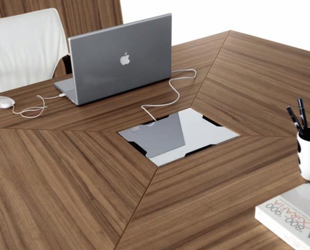 The square meeting table with compound worktops and relative storage units are in walnut melamined finish. Usable and aesthetically effective is the chromed central lid with slots for cables exit.