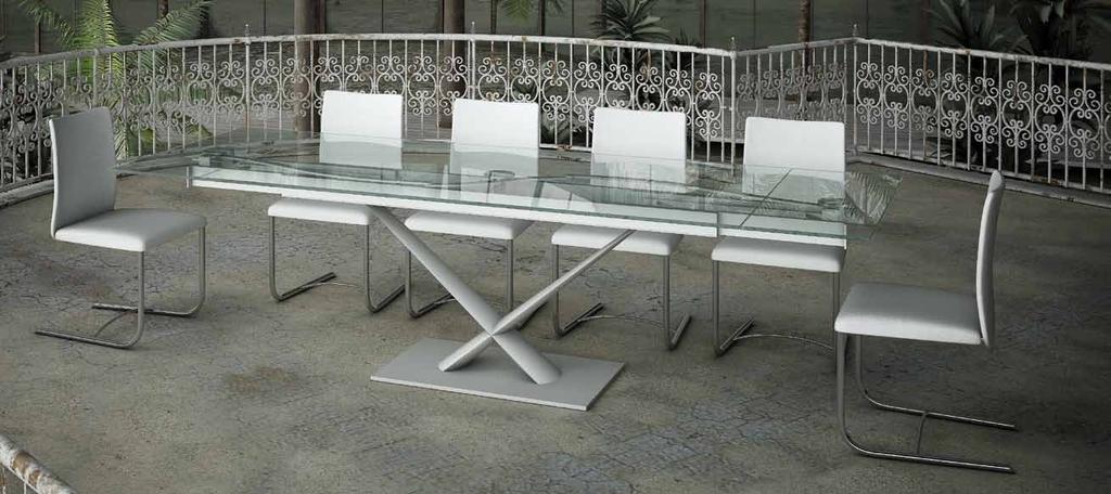 EXTENSIBLE DINING TABLE WITH GLASS OR WITH CERAMIC TOPS.EQUIPPED WITH AN EASY MECHANISM FOR SYNCHRONIZED LATERAL EXTENSIONS WIDENING. LEGS IN PAINTED STEEL. AVAILABLE WITH OR WITHOUT REMOTE CONTROL.