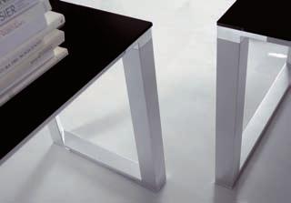 The polished white laminate finish matches with the black lacquered glass of the table top.