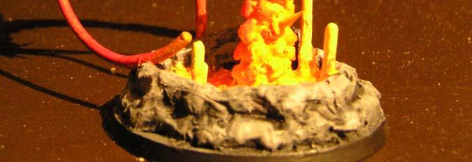Danach wurde das Modell mit Blazing Orange grob trocken gebürstet. Beim Trockenbürsten wurde darauf geachtet, dass die Raupe dort dunkler sein muss, wo sie schon länger aus der Lava herausragt.