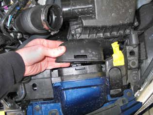 Remove the rubber grommet from the left air box mounting point.