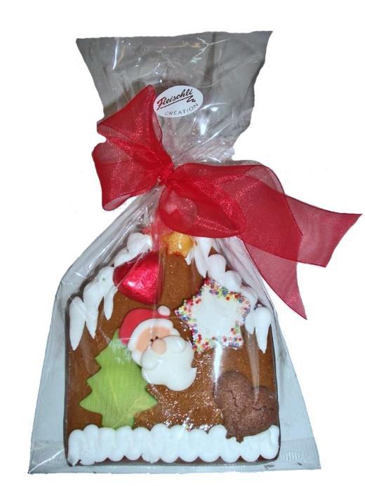 Lebkuchenhaus mit Samichlaus Ein lustiger Weihnachtsmann auf einem fröhlich dekorierten Haselnusslebkuchen-Haus, welches auf der Rückseite mit feinster Grand Cru Schokolade überzogen ist.