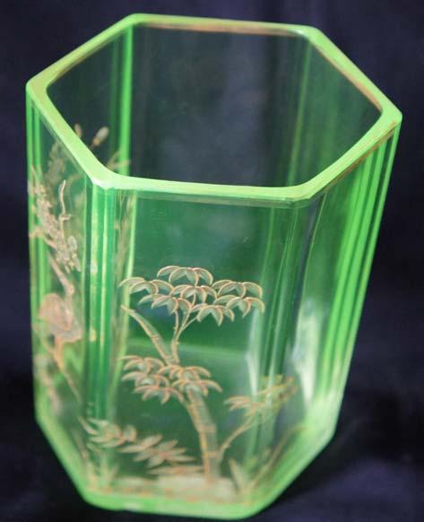 By the way, I have one uranium glass made in Bohemia. It is a flower vase of hexagonal shape, and its height is 15 cm, painted by gold with plum flowers, a crane bird, and bamboo trees.