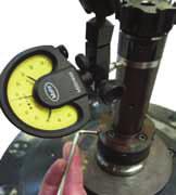 Set the llan-key at the closest screw vertically below the dial gauge and tighten it carefully until about half of the run-out is eliminated. 6.