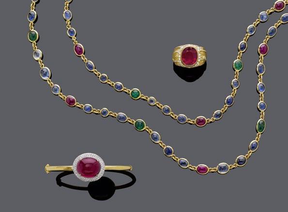 2254 2255 2256 A PAIR OF RUBY/SAPPHIRE GOLD RINGS. White and yellow gold 750, 21g. Set with 1 oval sapphire, resp. 1 oval ruby, each of ca. 2.50 ct, enhanced by a central line set with 21 ruby-, resp.