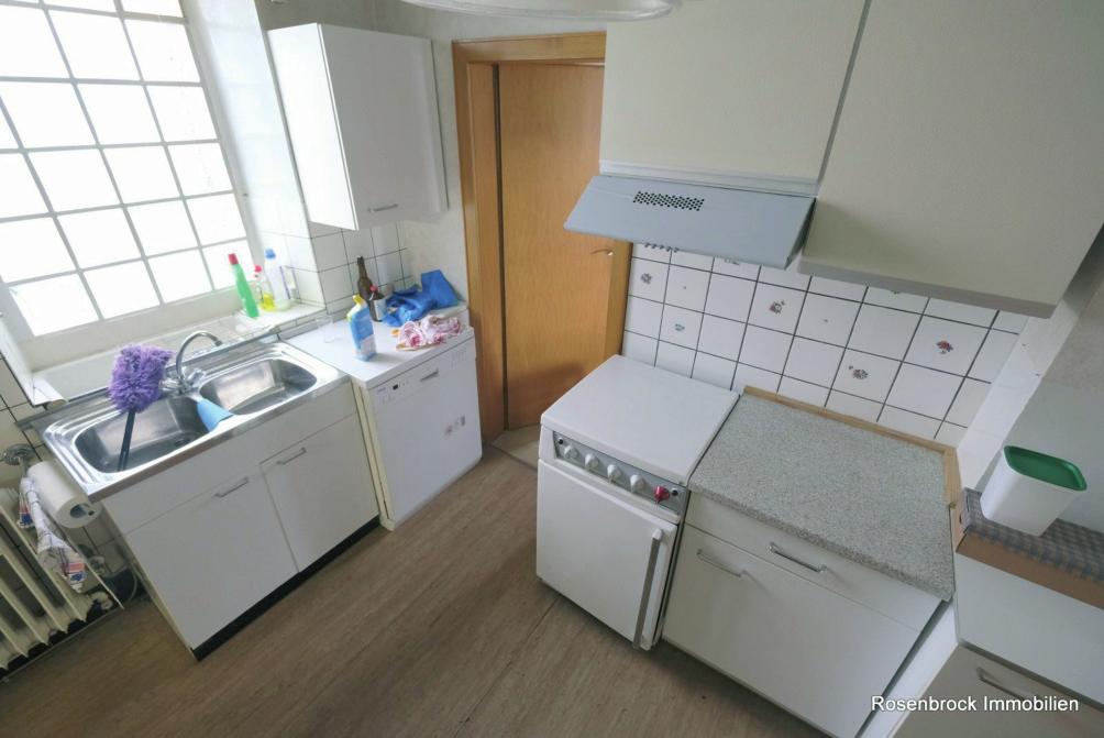 Die derzeitige Küche hat einen Zugang zum Wohn-Esszimmer, dem Flur und dem Hauswirtschaftsraum. Rechts im Bild ist der Kaminanschluss zu sehen.