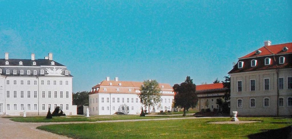 Im Hintergrund: Schloss Hubertusburg 1776. Der Kurfürst genehmigte sofort den manufakturtauglichen Umbau weiterer Gebäude im Schlossareal.