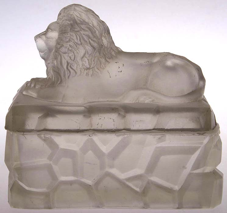 Abb. 2012-2/04-001 Deckeldose mit einem Löwen auf einem Felsen, farbloses Pressglas, mattiert Sammlung Glasmuseum Gus-Khrustalny, Hersteller Meisenthal, Lothringen / Frankreich, um 1900 Alla