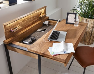 Useful detail: the movable desktop turns out to be a secret compartment with a charging station for a mobile phone, tablet and computer.