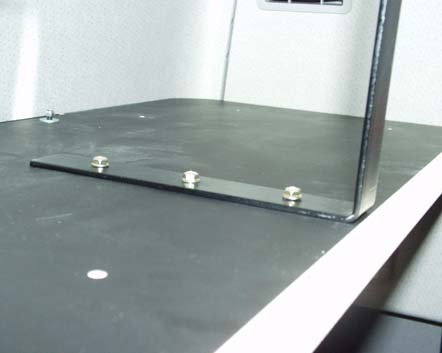 Verschrauben Sie die Bodenplatte mit den vorderen Metallabhängern pro Seite