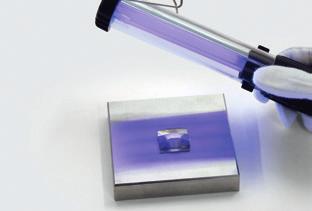 3 Den Kristall andrücken, bis der Klebstoff die komplette zu verklebende Fläche bedeckt. 4 Härten Sie den Klebstoff mittels UV-Lampe (lt.