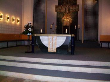 Der Altar Wenn man durch die große Tür in die Kirche kommt, sieht man den Altar. Im Altar liegt ein kleiner Knochen von einem heiligen Menschen, das nennt man Reliquie.