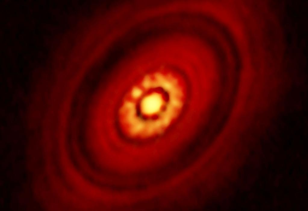 Fig. 4.10: Aufsicht auf die protoplanetare Scheibe von HL Tauri mit dem Millimeter-Array ALMA/ESO in Chile (November 2014). Der Durchmesser dieser Akkretionsscheibe beträgt ungefähr 100 AU.