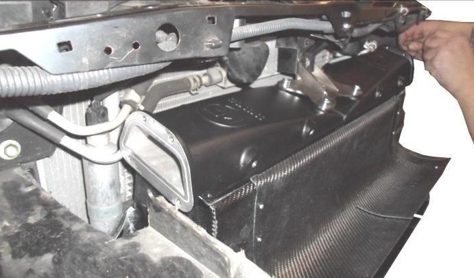 Mount the intercooler inclusive of the plastic front mask and the carbon air shroud to the car.