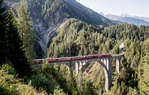 Der Naturstein- Viadukt ist 142 Meter lang und führt in kühnem Schwung über das wilde Landwassertal hinweg direkt hinein in einen Tunnel. Davos Platz.