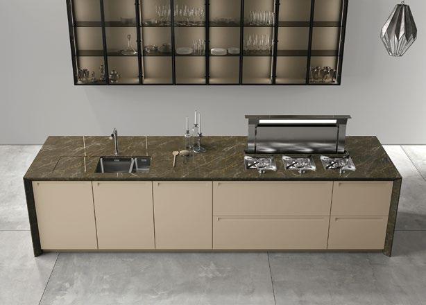 / A kitchen inspiring a scenic solidity thanks to the worktop in Amani Bronze marble and to the wall units with bronze glass and frames in