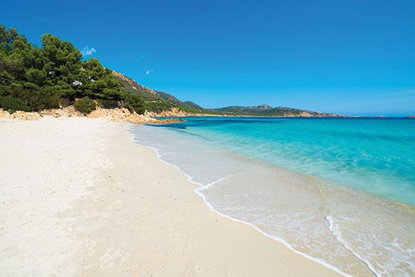 SARDINIEN MIT FLUG AB BRAUNSCHWEIG Azurblaues Meer und schneeweiße Strände. Im Wind schaukeln die Yachten und am Horizont türmen sich Bergmassive auf.