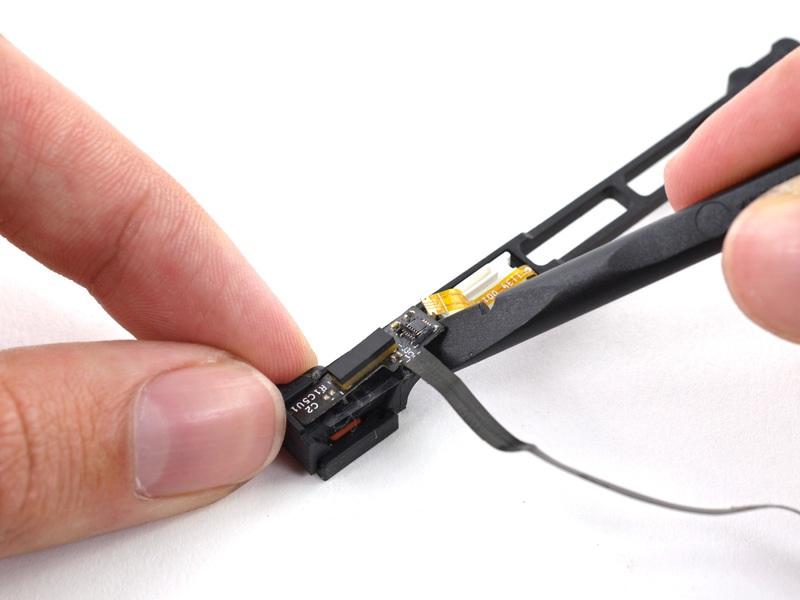 Nutze das flache Ende eines Spudgers, um das Festplattenkabel von dem Sensorhalter zu lösen.