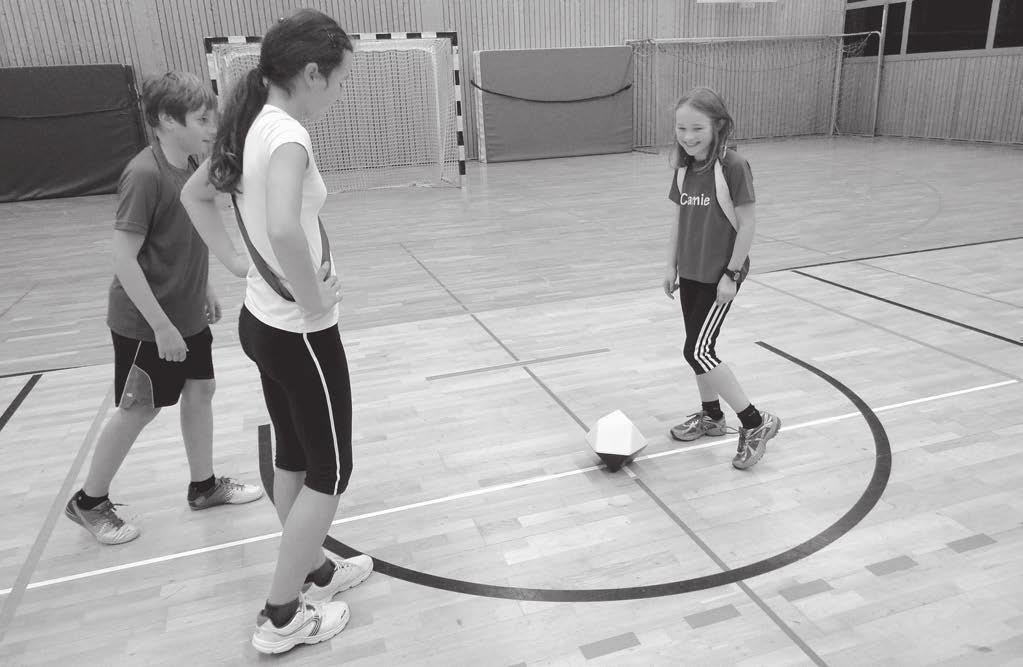 Tipp-Kick XXL-Ball Kapitel 2 Mit Hand und Fuß Beim Handball-Fußball geht es mit einem Anspiel für das weiße Team los Material: 1 Tipp-Kick XXL-Ball, 4 Pylonen, Parteibänder Spieldauer: 10 Minuten