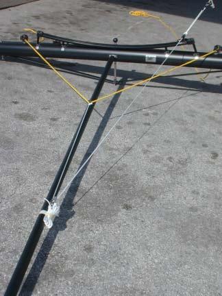 Selbstwende Fock 6 Now take the yellow thicker sheet rope and starting from one swivel cam cleat on the front crossbar pass the rope under the thinner white spectra rope through the middle size