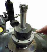 If there is not a setting screw directly below the gauge, tighten the closest screw below the gauge until the runout is further reduced.