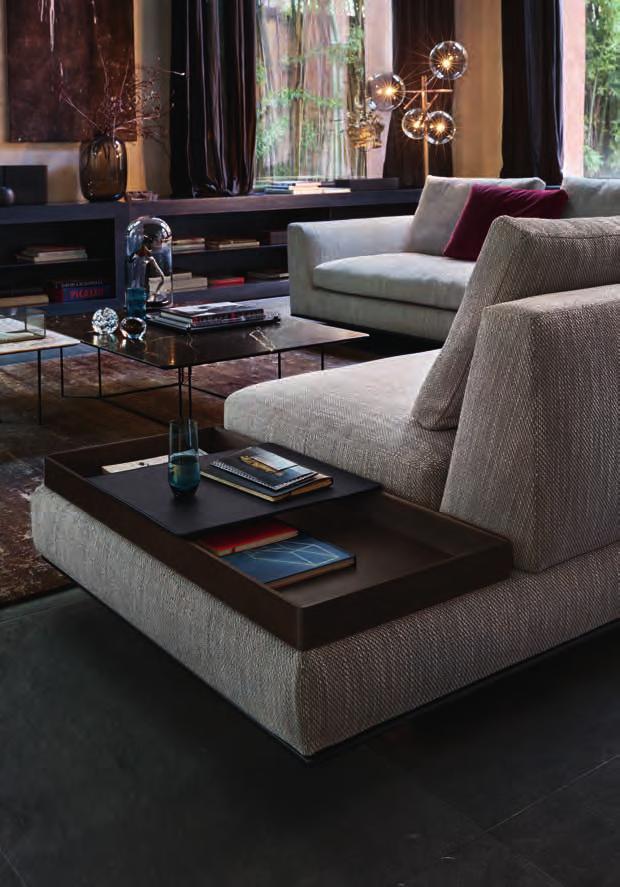 Storage and armrest in one. The side table continues the geometry of the sofa and extends the upholstered surface.