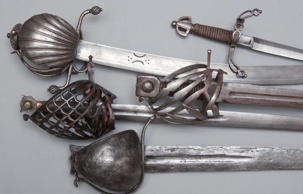 Main gauche, German, around 1600. Quillon and pommel broken off. Saber, German, around 1580. Scallop shell guard, quillon ends and pommel decorated with cross-hatching.